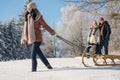 Young woman pulling winter sledge snow countryside