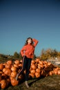 Young woman on a pumpkin farm. Beautiful girl near pumpkins. A girl with a pumpkin Royalty Free Stock Photo