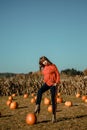 Young woman on a pumpkin farm. Beautiful girl near pumpkins. A girl with a pumpkin Royalty Free Stock Photo