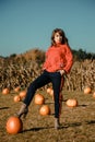 Young woman on a pumpkin farm. Beautiful girl near pumpkins. A girl with a pumpkin Royalty Free Stock Photo