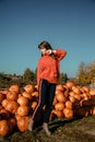 Young woman on a pumpkin farm. Beautiful girl near pumpkins. A girl with a pumpkin Royalty Free Stock Photo