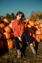 Young woman on a pumpkin farm. Beautiful girl near pumpkins. A girl with a pumpkin Royalty Free Stock Photo