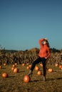 Young woman on a pumpkin farm. Beautiful girl near pumpkins. A girl with a pumpkin Royalty Free Stock Photo