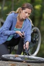 young woman pumps up tires bike