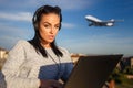 Young woman purchasing air ticket by laptop