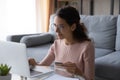 Young woman purchasing on internet use laptop and credit card