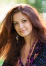 Young woman with purple beads at the summer park