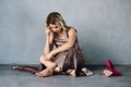 Young woman in purple dress sitting on a floor Royalty Free Stock Photo