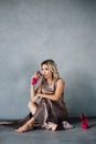 Young woman in purple dress sitting on a floor Royalty Free Stock Photo