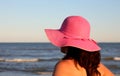 Woman in purple hat While sunbathing on the beach by the sea Royalty Free Stock Photo