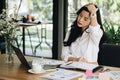 young woman put hand on head feeling tired, frustrated & stressed from hard work at office. exhausted businesswoman have headache