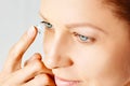 Young woman puts contact lens in her eye. Eyewear, eyesight and vision, eye care and health, ophthalmology and optometry concept, Royalty Free Stock Photo