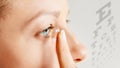 Young woman puts contact lens in her eye. Eyewear, eyesight and vision, eye care and health, ophthalmology and optometry concept, Royalty Free Stock Photo