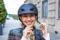 young woman putting bicycle helmet on street Royalty Free Stock Photo