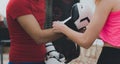 Young woman putting boxing gloves