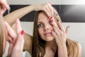 Young woman putting contact lens Royalty Free Stock Photo