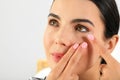 Young woman putting contact lens in her eye, closeup Royalty Free Stock Photo