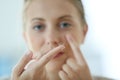 Young woman putting in contact lenses Royalty Free Stock Photo