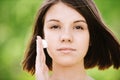 Young woman putting cream on her Royalty Free Stock Photo
