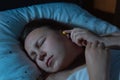 Young woman putting earplugs into her ears for the noise reduction before sleep, insomnia Royalty Free Stock Photo