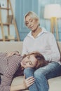 Young woman putting head on her mothers knees