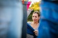 Young woman putting laundry on a rope in her garden Royalty Free Stock Photo