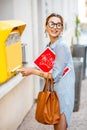 Woman using old mailbox outdoors Royalty Free Stock Photo