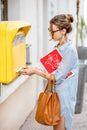 Woman using old mailbox outdoors Royalty Free Stock Photo