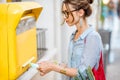 Woman using old mailbox outdoors Royalty Free Stock Photo