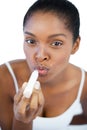 Young woman putting lip balm on her lips Royalty Free Stock Photo