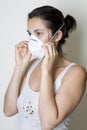 Young woman putting on a mask against swine flu Royalty Free Stock Photo