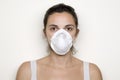 Young woman putting on a mask against swine flu Royalty Free Stock Photo