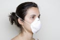 Young woman putting on a mask against swine flu