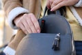 Young woman putting pepper spray into bag, closeup Royalty Free Stock Photo