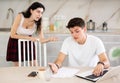 Young woman quarrels with young guy working at laptop Royalty Free Stock Photo