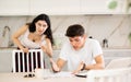 Young woman quarrels with young guy working at laptop Royalty Free Stock Photo