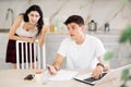 Young woman quarrels with young guy working at laptop Royalty Free Stock Photo