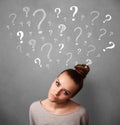 Young woman with question marks above her head Royalty Free Stock Photo