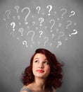 Young woman with question marks above her head Royalty Free Stock Photo