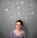 Young woman with question marks above her head Royalty Free Stock Photo