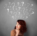 Young woman with question marks above her head Royalty Free Stock Photo