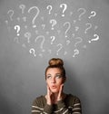 Young woman with question marks above her head Royalty Free Stock Photo