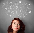 Young woman with question marks above her head Royalty Free Stock Photo