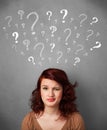 Young woman with question marks above her head Royalty Free Stock Photo