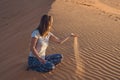 Young woman in rad sandy desert at sunset Royalty Free Stock Photo