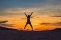 Young woman in rad sandy desert at sunset Royalty Free Stock Photo