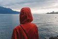 Young woman in a rain coat in front of Lake Geneva in Switzerland Royalty Free Stock Photo