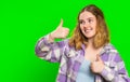 Young woman raises thumbs up agrees or gives positive reply recommends advertisement likes good idea