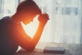 Young woman raising hands praying at sunset or sunrise light Royalty Free Stock Photo