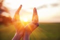 Woman raising hands praying at sunset or sunrise light Royalty Free Stock Photo